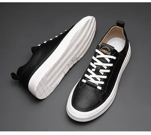 Detailed macro shot of black leather low-top casual sneakers with white thick soles.