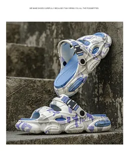 Macro view of camo pattern clogs with adjustable buckle strap on stone steps.