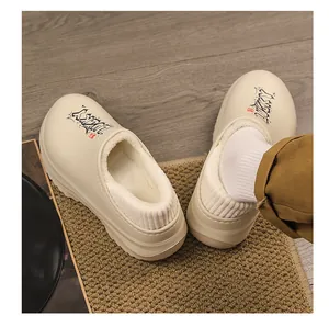Close-up detail of beige fleece-lined winter clogs featuring thick platform soles and lining