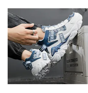 Side view of white and blue men's high-top chunky sneakers with denim details.