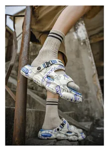 Close-up of men's camouflage sports clogs with adjustable heel strap worn on stairs