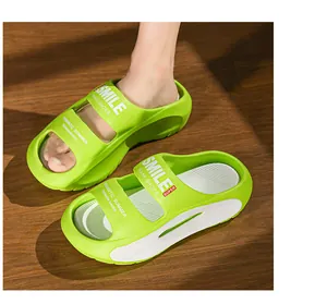 Detailed view of lime green EVA platform slides featuring white SMILE printed straps on top