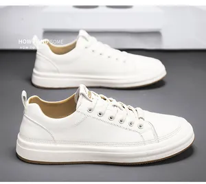 Detail view showing the textured cowhide leather of high-quality white men's sneakers.