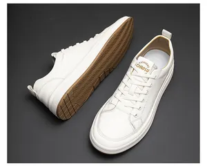 Detail of high-quality white leather low-top sneakers with a durable brown gum sole.