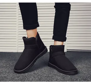 Macro view of black suede snow boots with stylish side buckle and thick warm lining