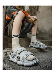 Detailed close-up view of men's trendy grey graphic sports sandals featuring a thick non-slip sole