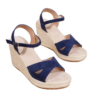 Blue suede wedge sandals featuring straw-braided espadrille soles and ankle straps