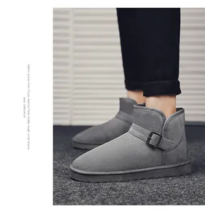 Close-up detail of grey suede snow boots featuring a stylish metal side buckle