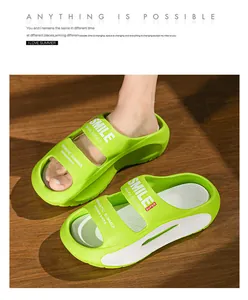 Detailed view of trendy bright green slippers with SMILE print on wooden floor