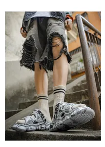 Men's chunky sporty clogs with abstract pattern in urban lifestyle setting
