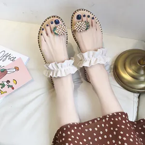 Detailed close-up of summer women's flat sandals featuring pearl pineapple and ruffled straps