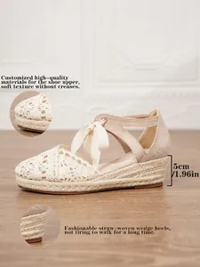Detalle de sandalias de cuña en crochet con tacón de paja de 5 cm y lazo de cinta
