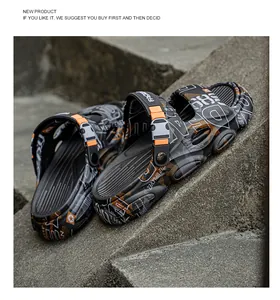 Detail view of trendy men's graffiti clogs with thick soles and adjustable straps