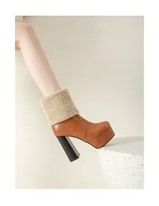 Macro view of stylish brown platform ankle boot featuring a chunky heel and fleece collar