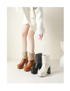 Close-up of fleece-lined platform ankle boots with high block heels in brown, black and white