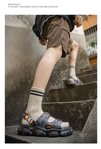Detailed view of men's chunky sports sandals with graffiti patterns and orange accents