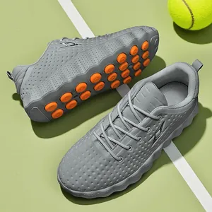 Breathable gray river-tracing shoes with orange anti-slip sole pods on sports court