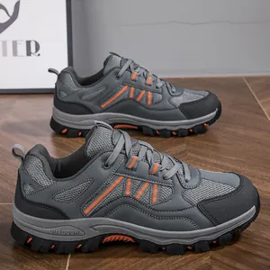Grey outdoor hiking shoes for men with non-slip soles and orange accents for trekking