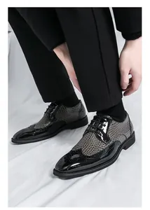 Nahaufnahme von stilvollen zweifarbigen Brogue-Schuhen für Herren, die getragen werden