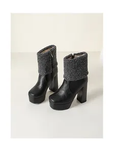 Side view of black platform high heel boots with grey sherpa fleece collar detail