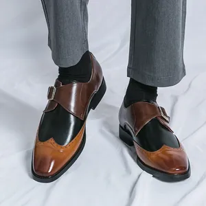 Elegant men's tricolor wingtip monk strap dress shoes featuring a sleek pointed toe design
