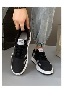 Close-up detail of black and white board shoes with Fashion tongue label detail
