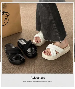 Detail of comfortable platform sandals with crisscross straps in black and white colors