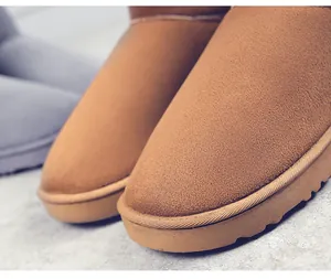 Macro view showing the fine suede texture and sturdy sole of warm tan snow boots