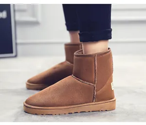 Detailed side view of brown suede snow boots with thick warm fleece lining for winter