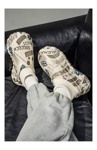 Detail view of newspaper print puffy cotton shoes with ribbed knit cuff and thick sole