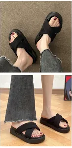 Close-up view of women's comfortable black criss-cross platform slides for summer beach wear