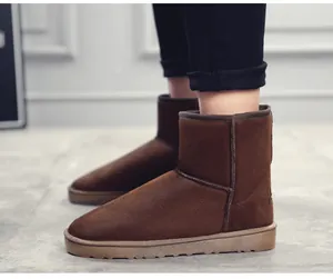 Side view of brown suede snow boots worn on feet, showing the soft texture and durable sole.