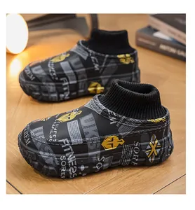 Close-up of black platform winter cotton shoes with graffiti print and sock collar.