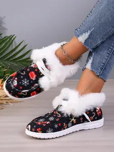 Detail of Christmas themed cotton boots with plush faux fur lining and festive patterns