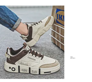 Detailed side profile of beige and brown casual men's sneakers on a grey surface