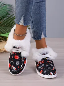 Detailed shot of Christmas pattern winter boots with white faux fur lining and thick sole