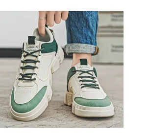 Close-up detail of men's trendy white and green sneakers with soft chunky soles