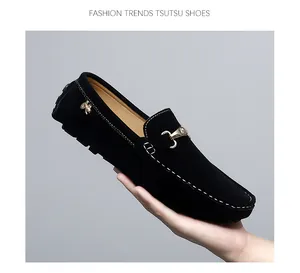 Close-up of black suede men's loafer with gold horsebit and contrast stitching