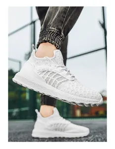Detailed close-up of white breathable mesh running shoe with thick cushioning sole