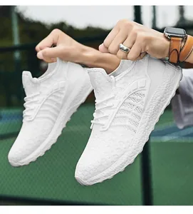 Close-up of white breathable flyknit mesh sneakers showing texture and design detail