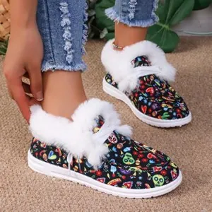 Close-up of warm winter boots with colorful graffiti print and white faux fur trim.