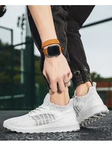 Detailed side view of white lightweight breathable fly-knit running shoe for men and women.