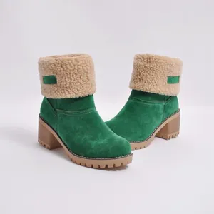 Detail of green suede boots with warm beige sherpa collar and chunky wooden block heels.