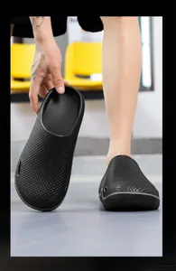Detailed macro view showing the textured surface of men's black slip-resistant chef clogs
