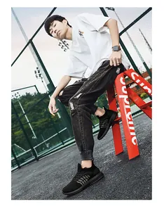 Black lightweight breathable fly-knit sneakers worn by male model in outdoor setting
