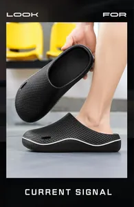 Detail view of black non-slip chef clogs with textured finish and white sole accent