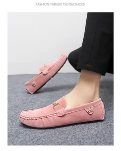 Detailed view of pink suede men's loafers with metal buckle and decorative stitching