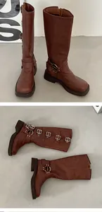 Detailed view of women's brown knee-high boots featuring silver buckles and thick soles.