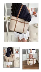 Detailed view of cream minimalist tote bag with brown trim and shoulder strap