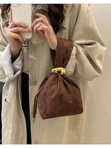 Vintage pleated brown suede designer bucket handbag with gold sculptural metal ring